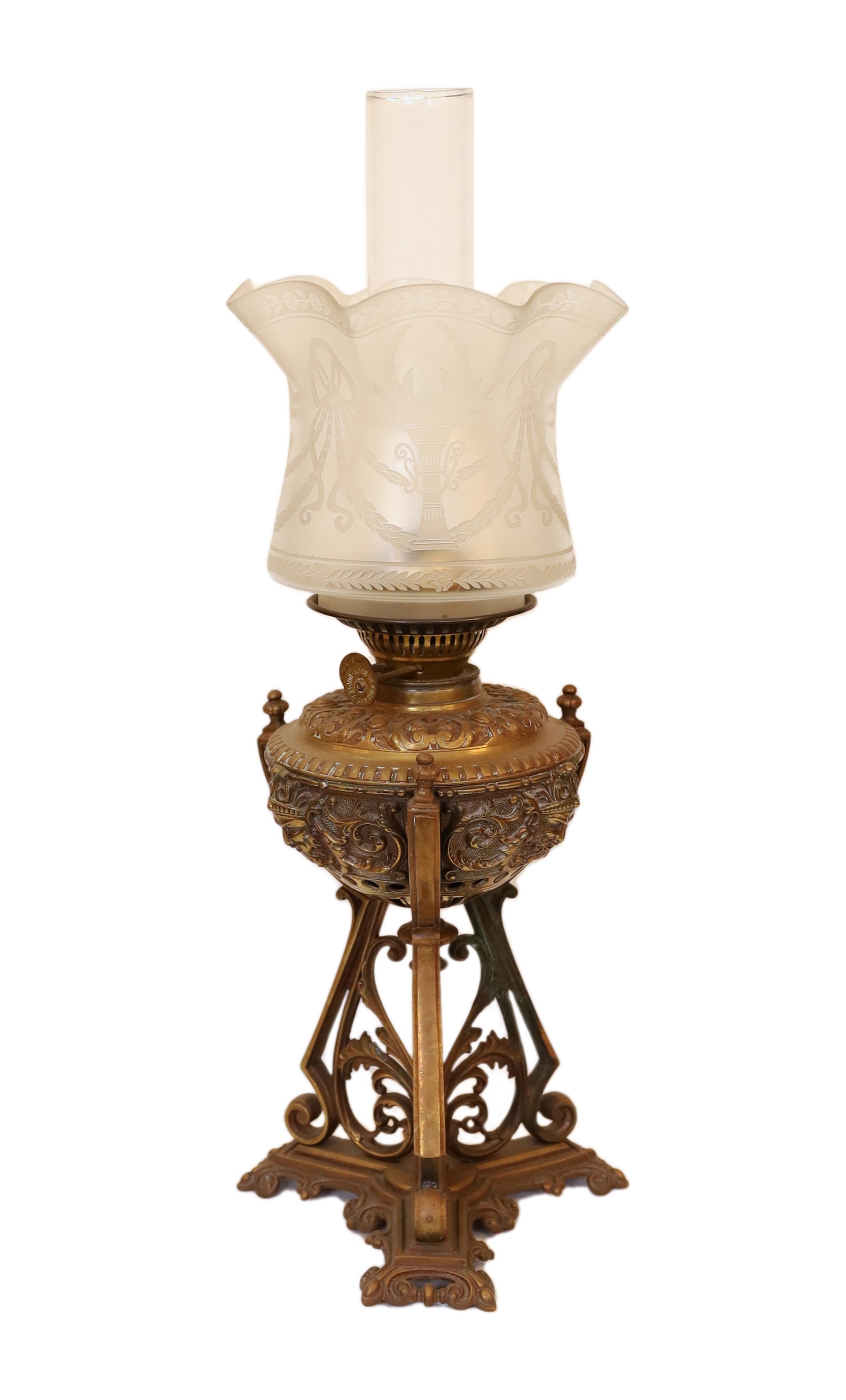 A Victorian bronze Renaissance revival oil lamp, decorated with masks and scrolls, with duplex mechanism, frosted glass shade and flue, height overall 58cm